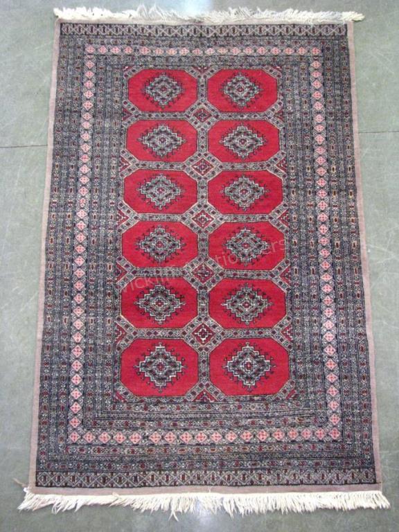 Appraisal: A handmade Oriental rug Pak Bukhara pattern red field '