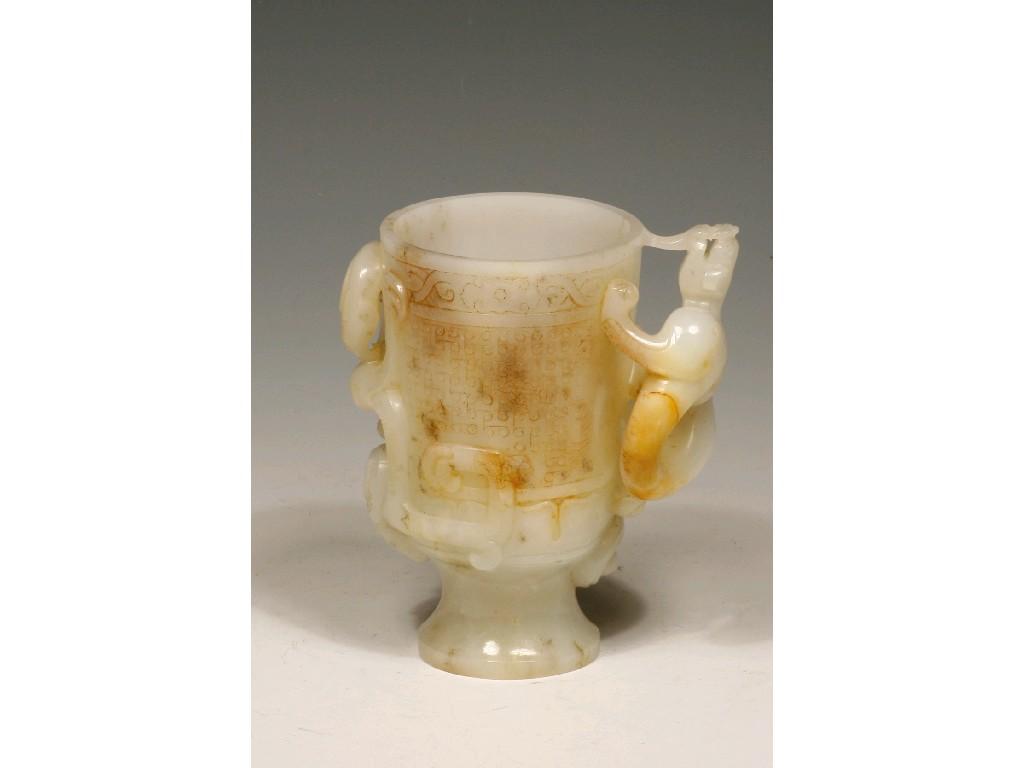 Appraisal: A WHITE JADE GOBLET decorated in relief with mythical beasts