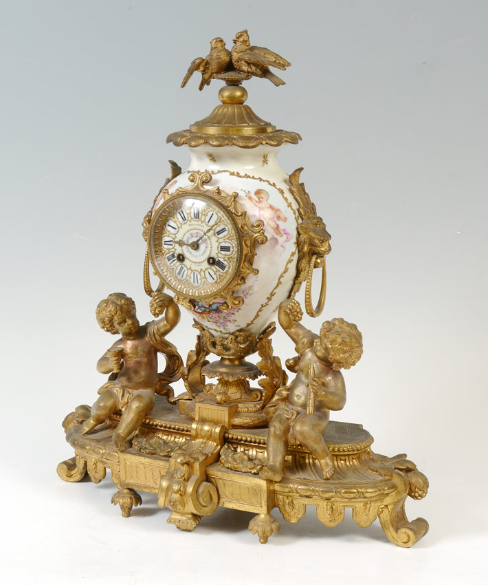 Appraisal: FRENCH BALTHAZAR FIGURAL GILT AND PORCELAIN CLOCK Cast gilt metal