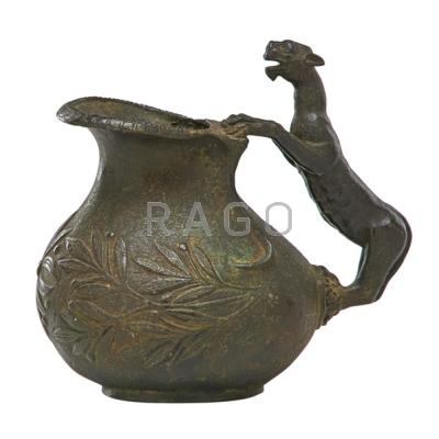 Appraisal: ARCHAIC BRONZE PITCHER Figural leopard handle floral and vine decoration