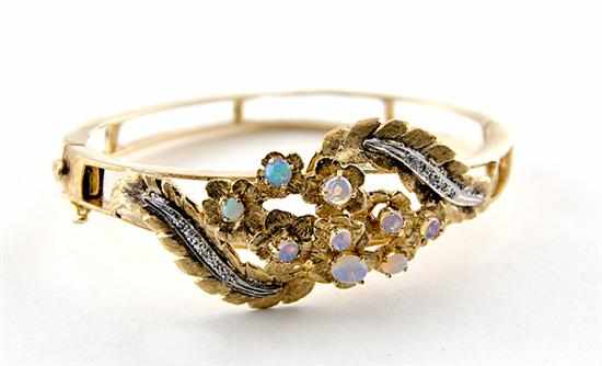 Appraisal: Opal diamond and gold cuff bracelet centered by floral-set opals