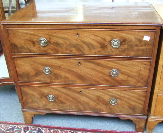 Appraisal: A th century mahogany chest of three long drawers raised