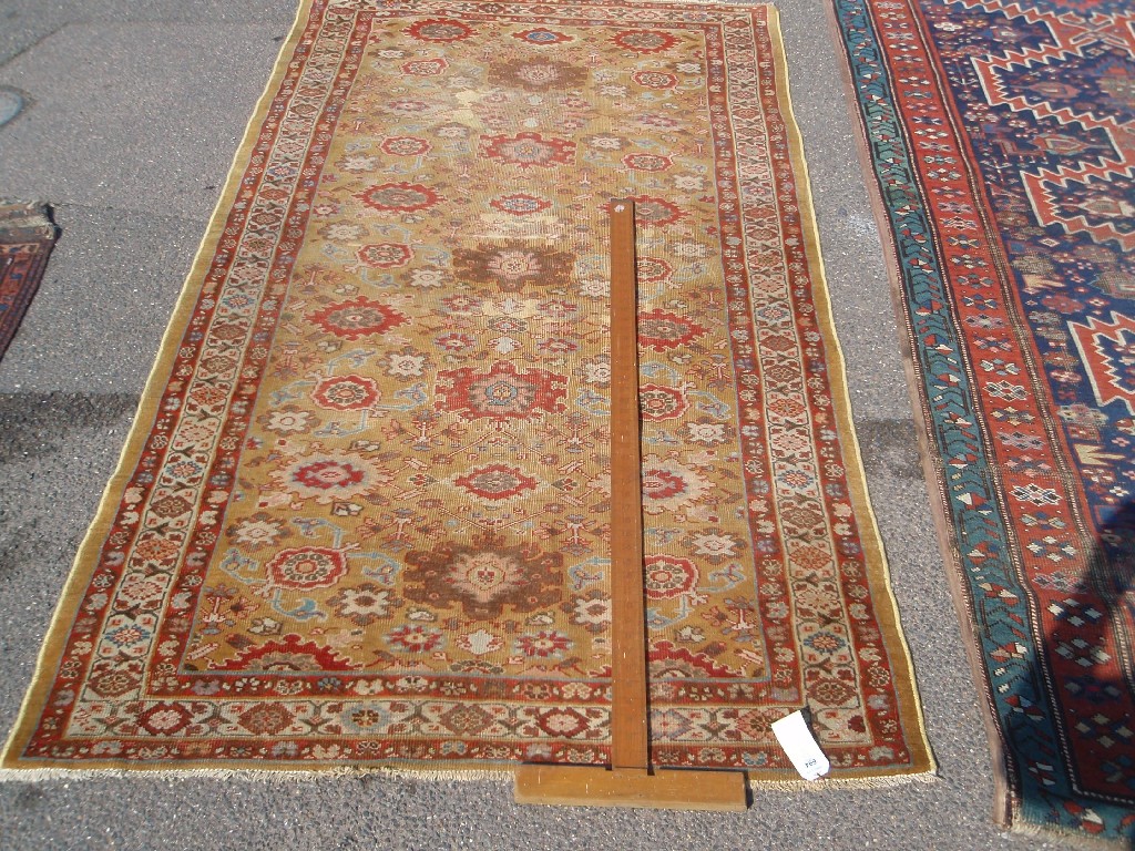 Appraisal: A Persian design mustard ground rug cm x cm