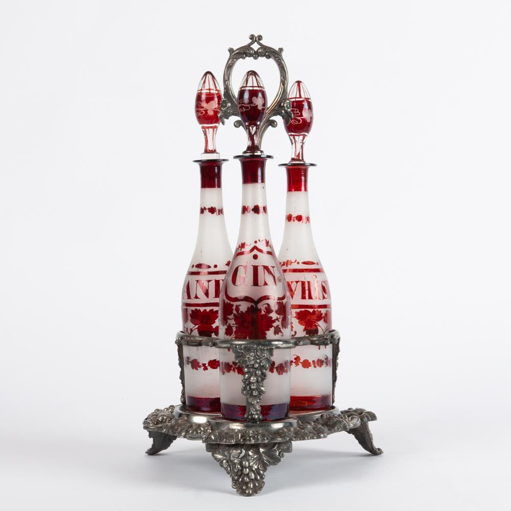 Appraisal: SHEFFIELD TANTALUS WITH HAND-CUT GLASS DECANTERS A silver-plated decanter stand