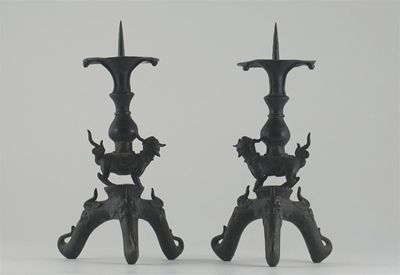 Appraisal: A pair of Chinese bronze tripod pricket candlesticks each stem