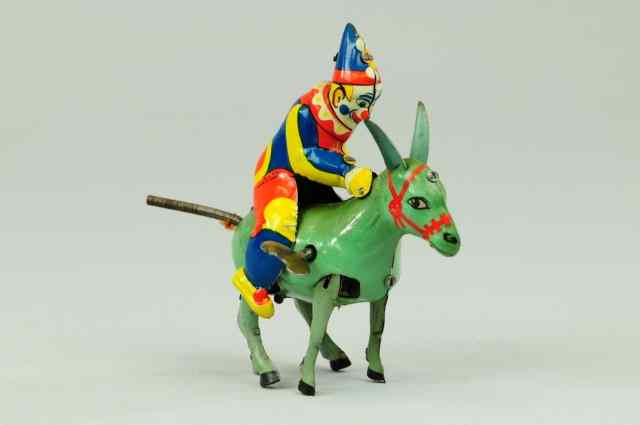 Appraisal: CLOWN RIDING DONKEY Germany colorful tin litho toy depicts clown