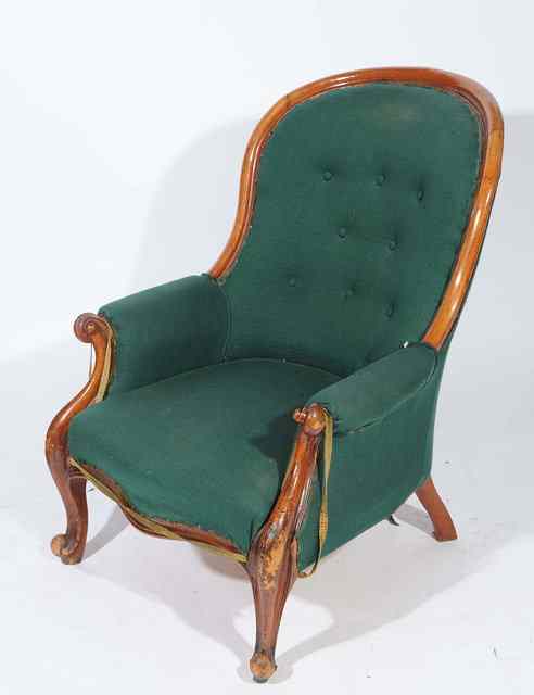 Appraisal: A BUTTON BACK UPHOLSTERED ARMCHAIR with scrolling supports