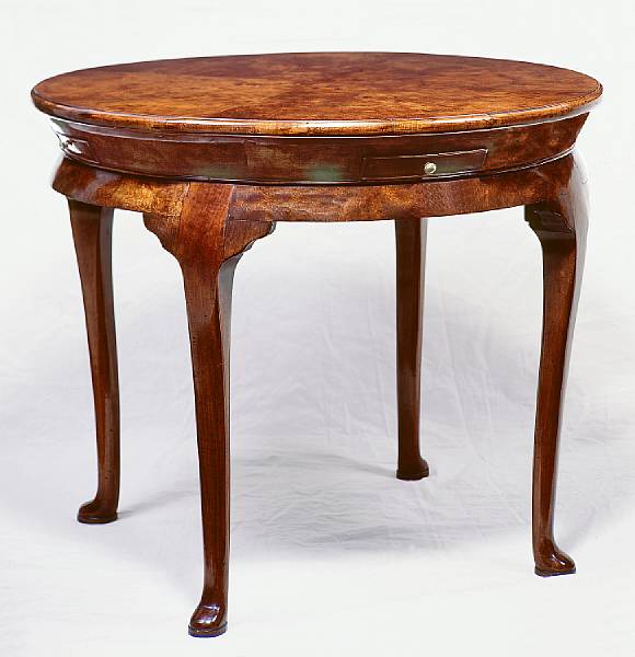 Appraisal: A Queen Anne style walnut circular low table Raised on