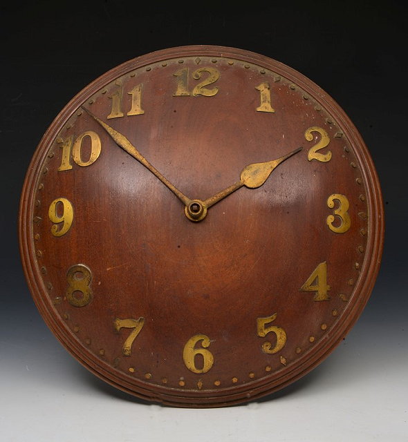 Appraisal: AN ARTS AND CRAFTS MAHOGANY WALL TIMEPIECE the convex dial