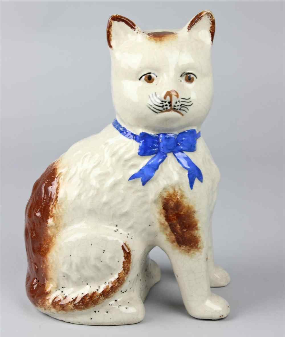 Appraisal: CERAMIC MODEL OF A CAT seated with blue ribbon around