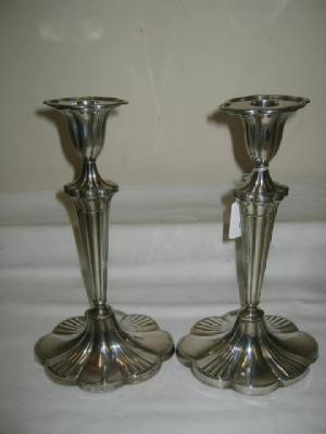 Appraisal: A PAIR OF CANDLESTICKS of lobed oval form with moulded