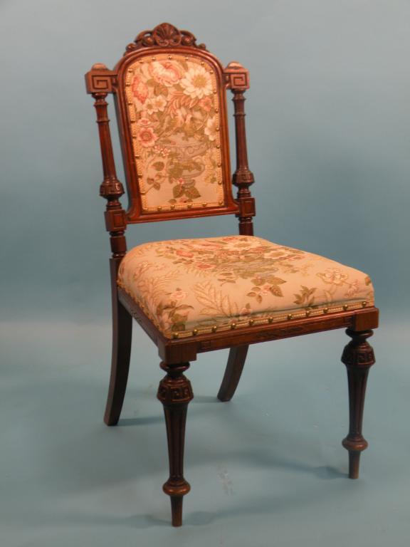 Appraisal: A Victorian carved walnut side chair with a padded back