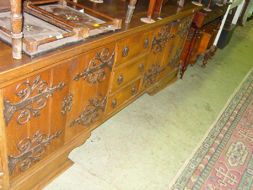 Appraisal: A substantial oak sideboard fitted with an arrangement of cupboards