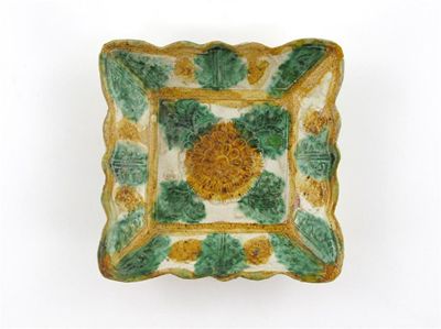 Appraisal: A Chinese pottery square dish moulded with flowerheads and foliage