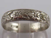 Appraisal: A carved white metal tests platinum ring gms size U