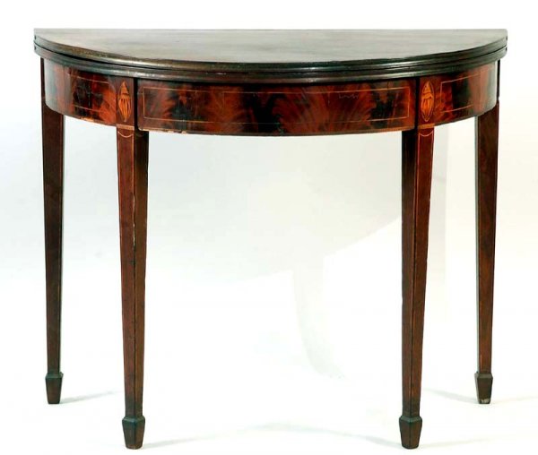 Appraisal: The demilune flip top resting on four spade-feet two fixed