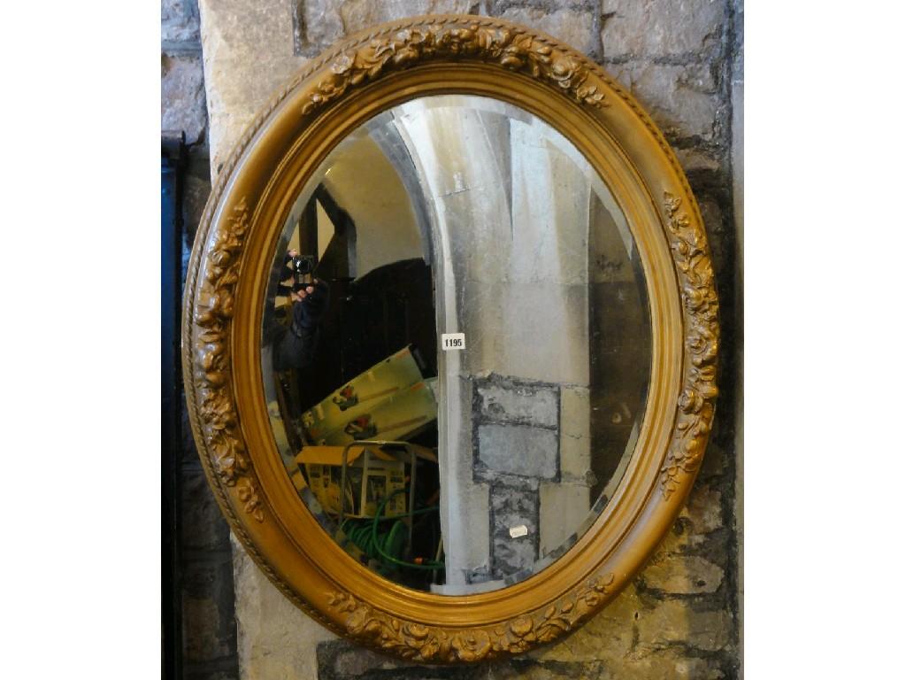 Appraisal: A Victorian wall mirror of oval form the bevelled edge