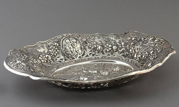 Appraisal: A sterling basket with repousse ornament and reticulated border height