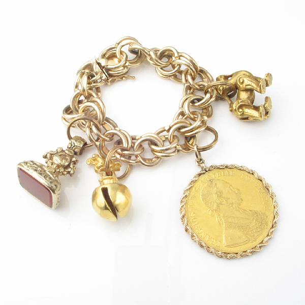 Appraisal: A fourteen karat gold charm bracelet with gold silver and