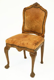 Appraisal: A CONTINENTAL WALNUT HALL CHAIR The shaped leather upholstered back