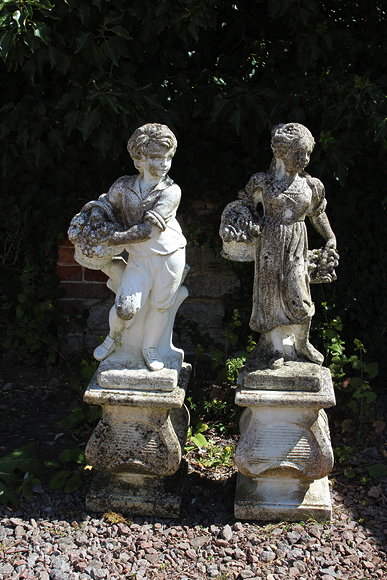 Appraisal: A PAIR OF CAST CONCRETE SCULPTURES one of a boy