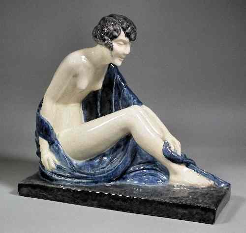 Appraisal: A French Etling seated pottery figure - A scantily clad