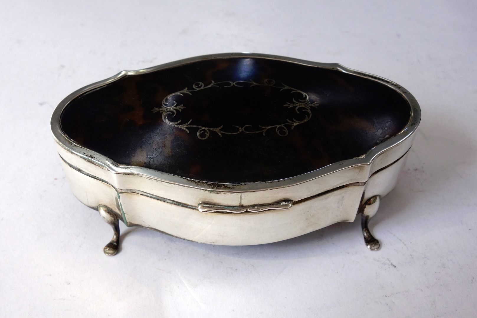 Appraisal: A silver and tortoiseshell jewel box probably Birmingham of shaped