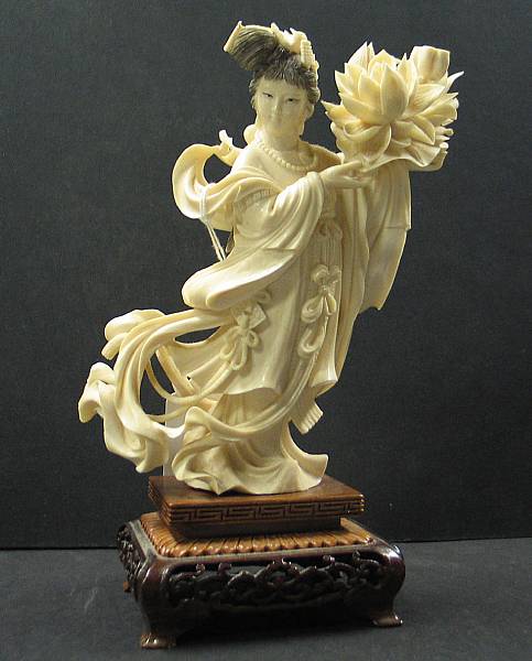 Appraisal: An ivory carving of a beauty with a lotus blossom