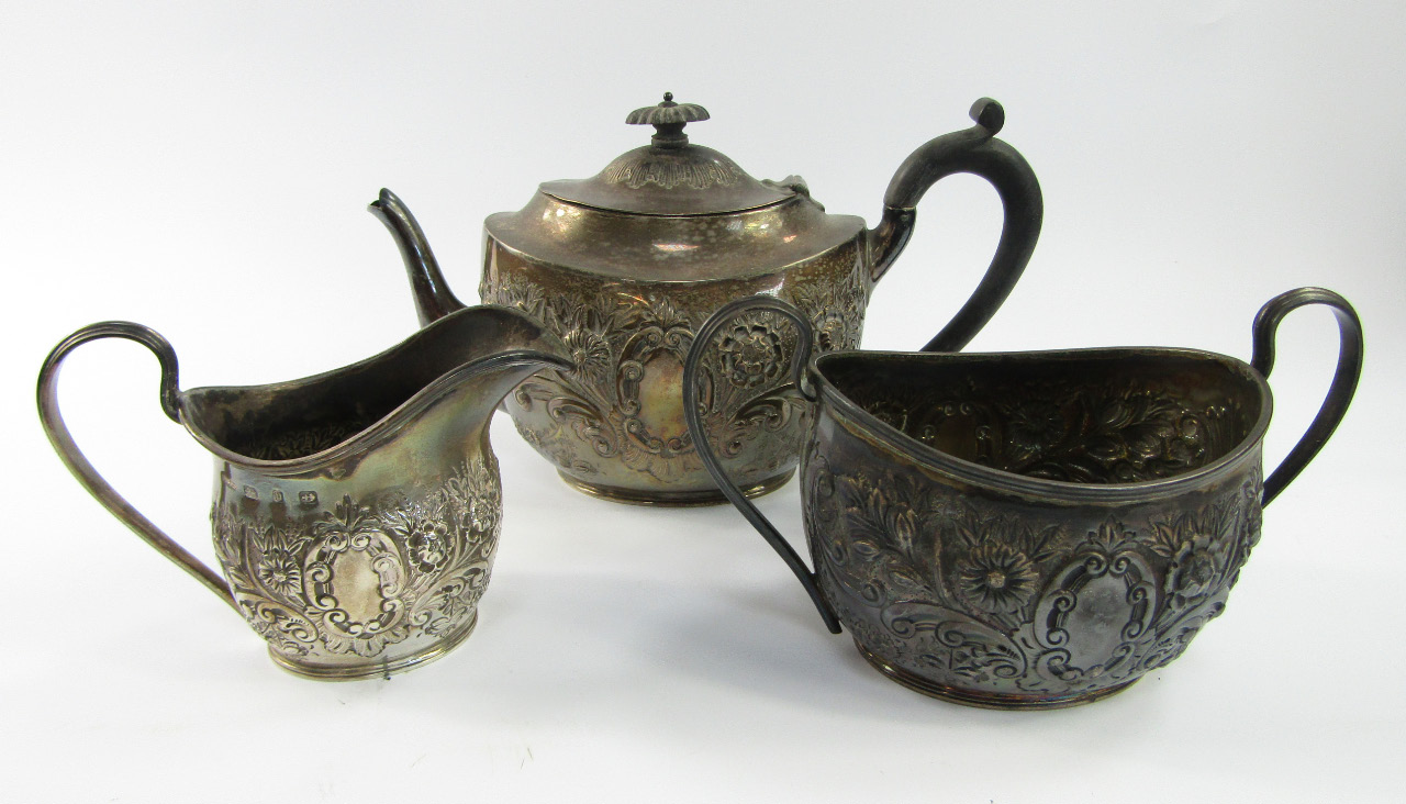 Appraisal: A Victorian silver three piece tea set embossed with flowers