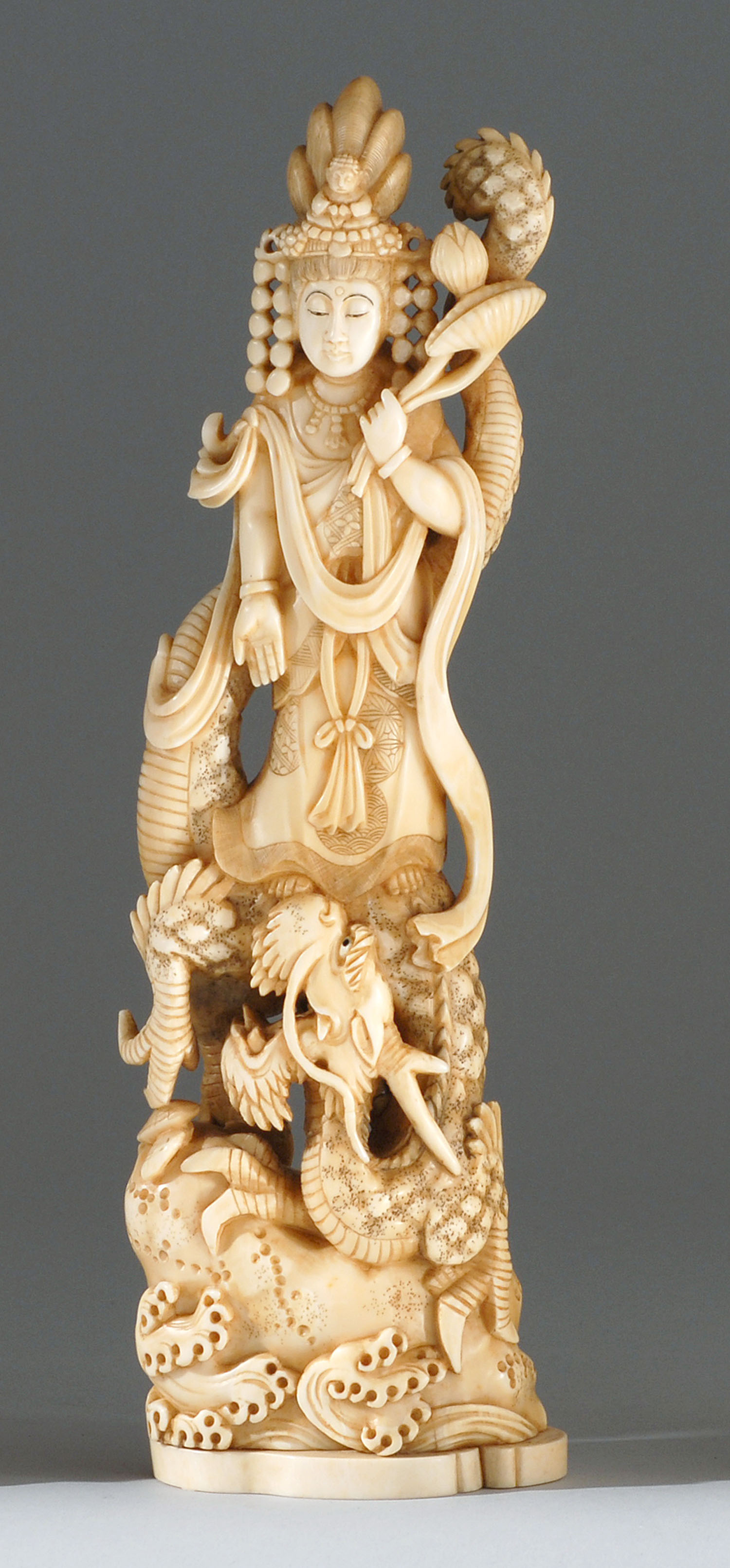 Appraisal: IVORY CARVING Meiji PeriodDepicting Kwannon standing on a dragon while