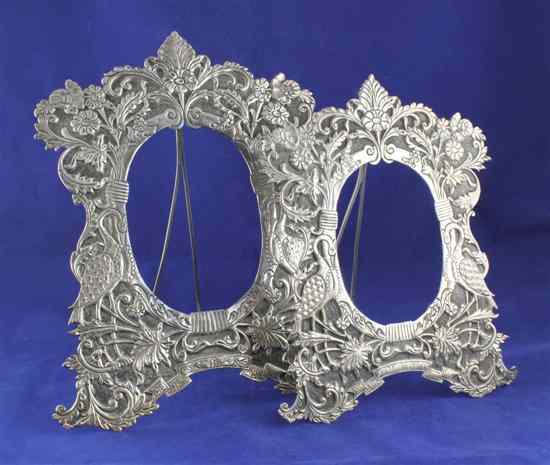 Appraisal: Two graduated Indian white metal photograph frames embossed with exotic