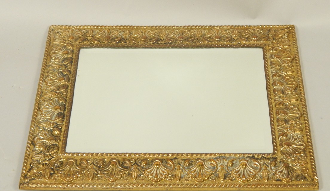 Appraisal: An early thC brass framed wall mirror inset bevelled glass