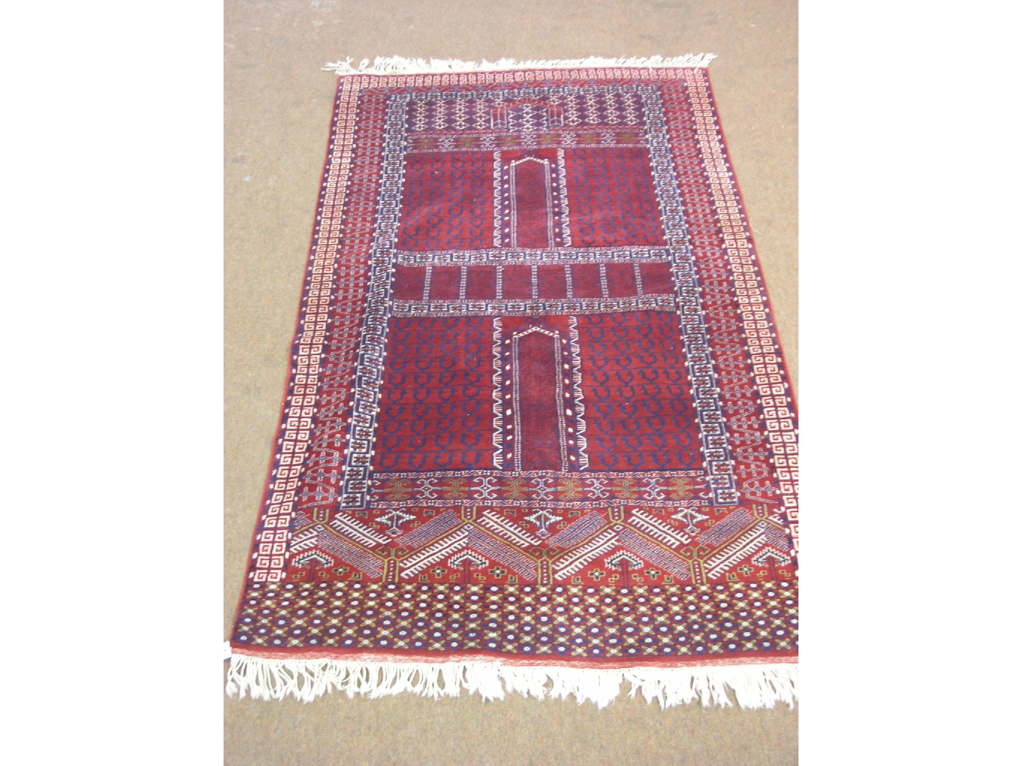 Appraisal: An Eastern wool prayer rug finely-knotted design predominantly in red