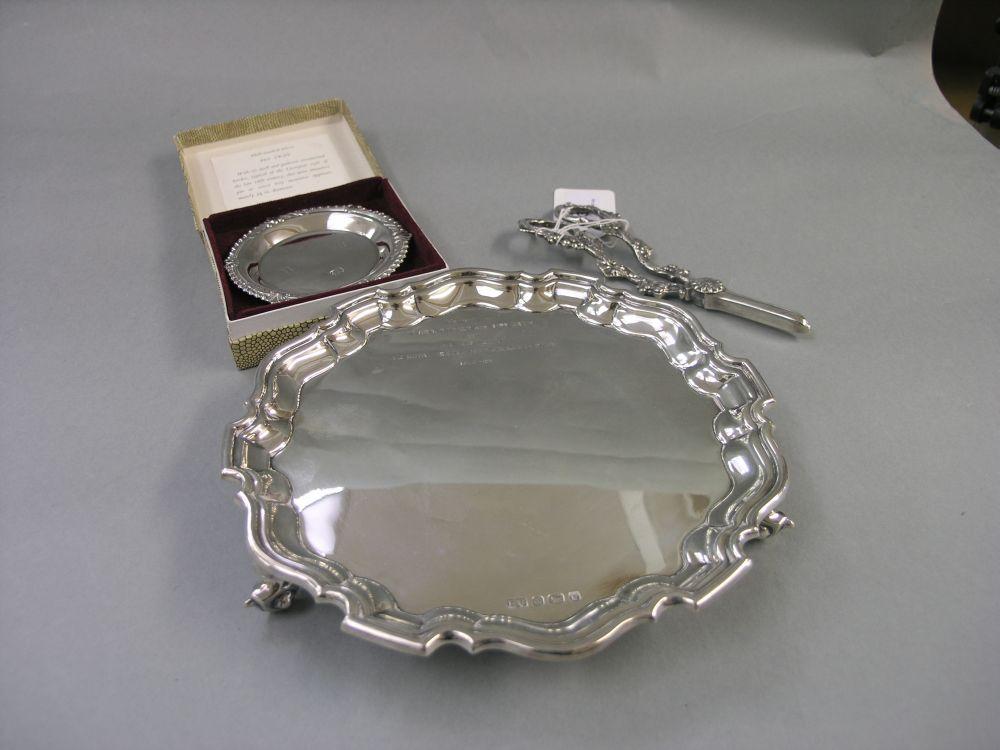 Appraisal: A silver salver with piecrust rim on knurled feet Sheffield