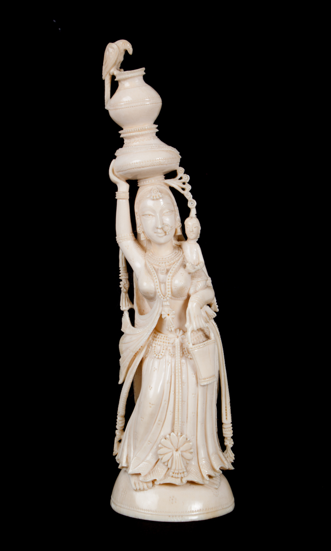 Appraisal: Indian carved ivory female figure modeled as woman holding child