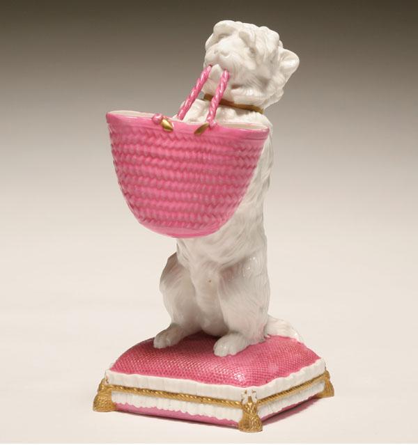 Appraisal: Ceramic Staffordshire dog with basket obedient terrier seated on pillow