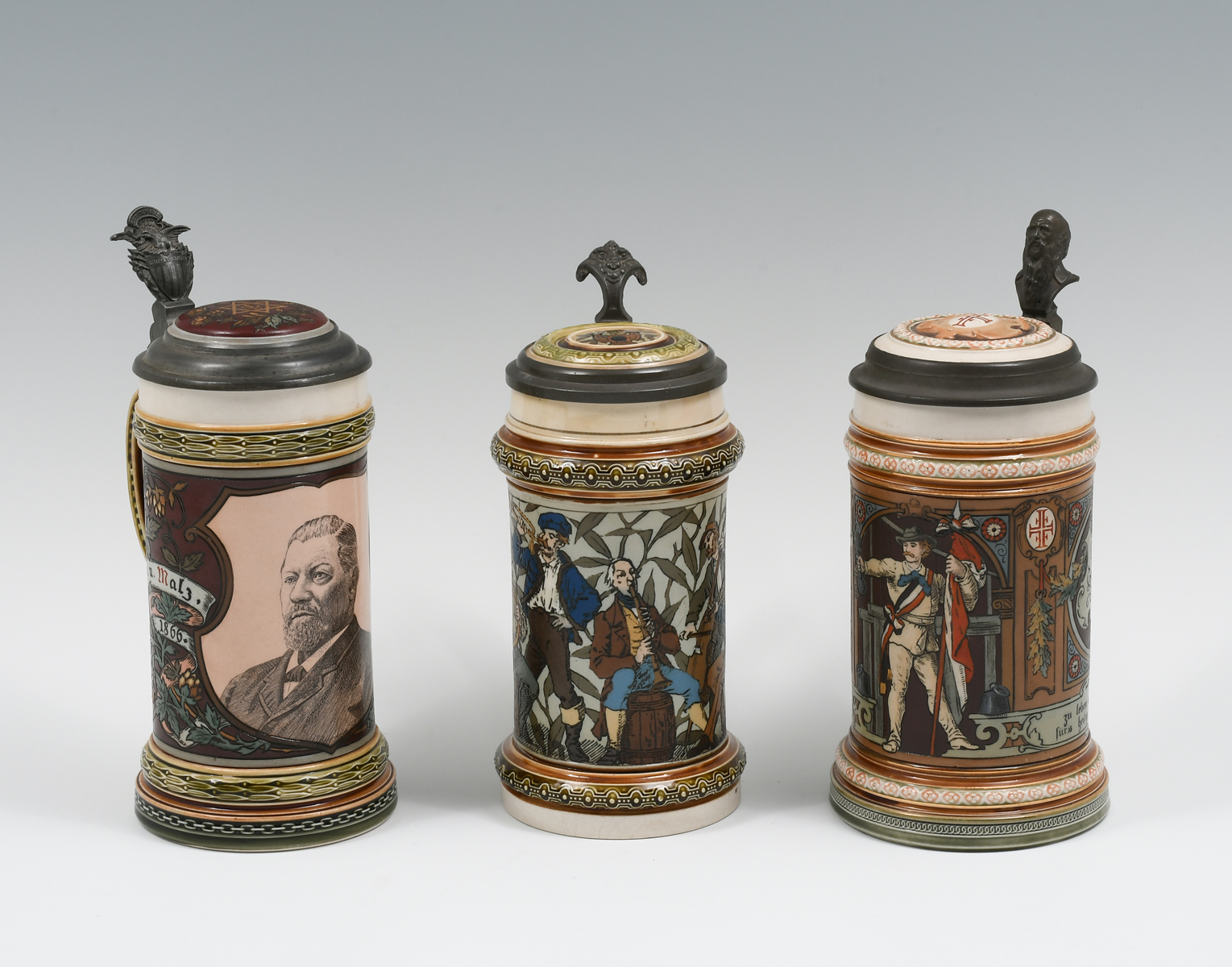 Appraisal: PC METTLACH FIGURAL BEER STEINS Comprising - Mettlach L having