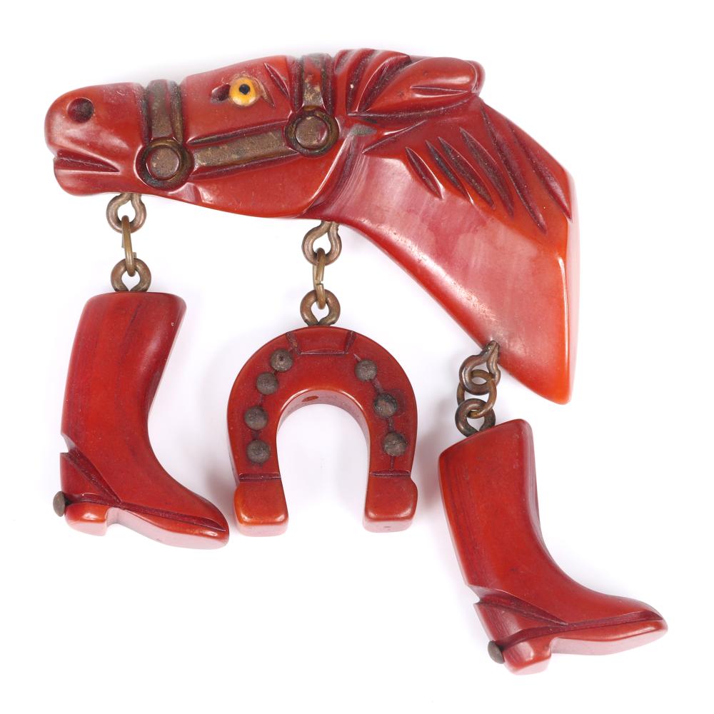 Appraisal: VINTAGE BAKELITE EQUESTRIAN FIGURAL HORSE HEAD PIN WITH DANGLING RIDING