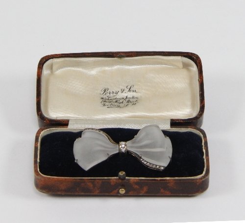 Appraisal: A frosted glass and diamond bow brooch the bow centred