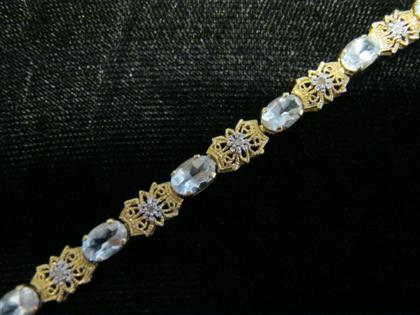 Appraisal: karat yellow gold and aquamarine braceletAlternating filigree diamond set links