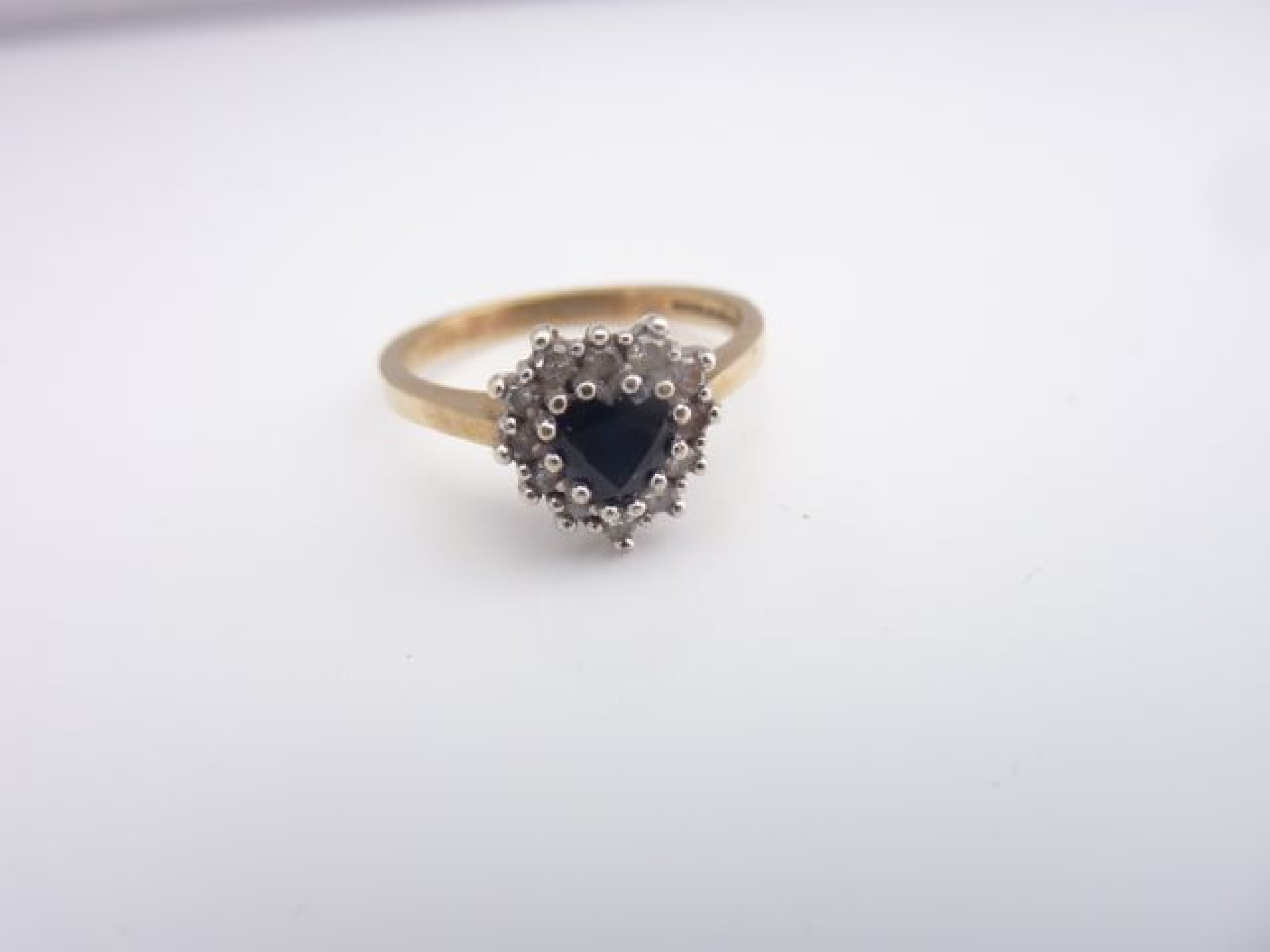 Appraisal: A sapphire and diamond ring centred with a heart-shaped sapphire