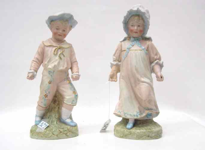 Appraisal: PAIR GERMAN HEUBACH BISQUE FIGURINES of a young boy and