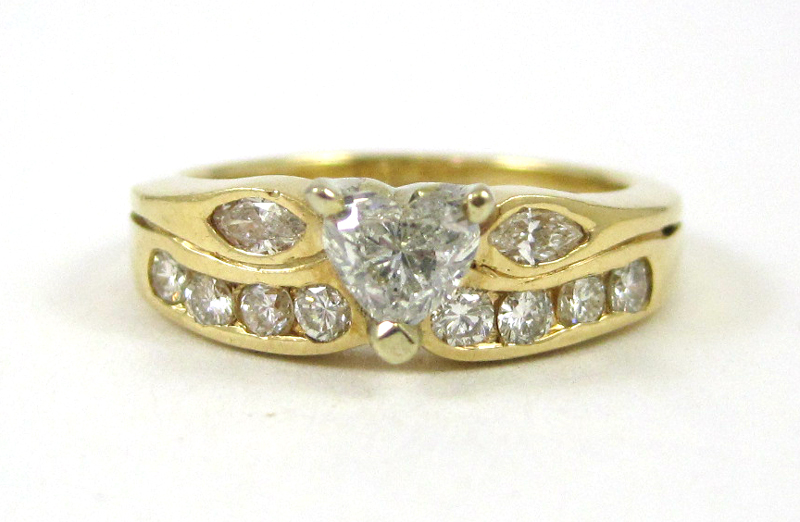 Appraisal: DIAMOND AND FOURTEEN KARAT GOLD RING set with two marquise-cut