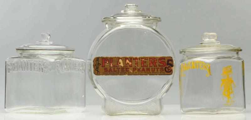 Appraisal: Lot of Planters Peanut Jars The lid for the square