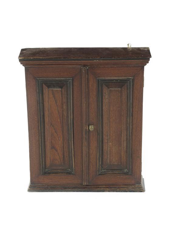 Appraisal: A teak and ebonised wall cabinet