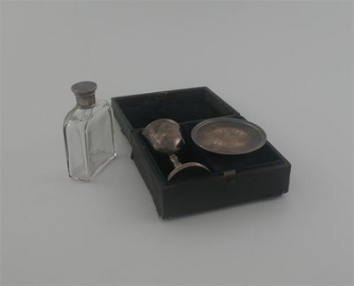 Appraisal: A Victorian cased travelling communion set comprising a mounted glass