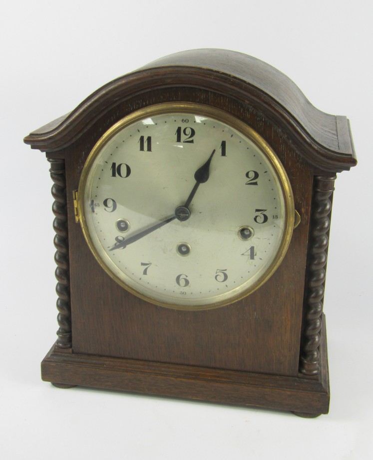 Appraisal: A German oak cased early thC mantel clock silvered dial