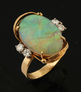 Appraisal: An opal and diamond ring The oval solid crystal opal