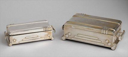 Appraisal: TWO ART DECO SILVER-PLATED GRADUATED CIGARETTE BOXES Each hinged lid