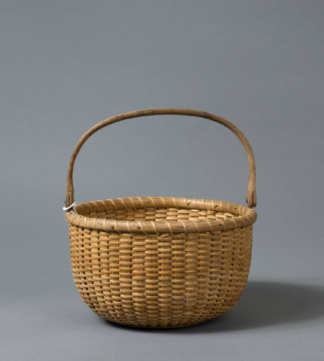 Appraisal: CIRCULAR NANTUCKET BASKET BY FERDINAND SYLVARO - With shaped swing